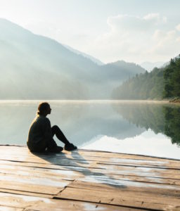 Woman near the lake in mountains stock photo