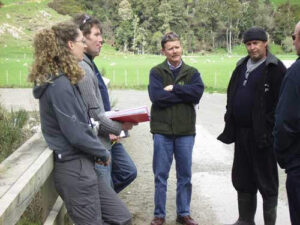 People talking informally on a bridge.